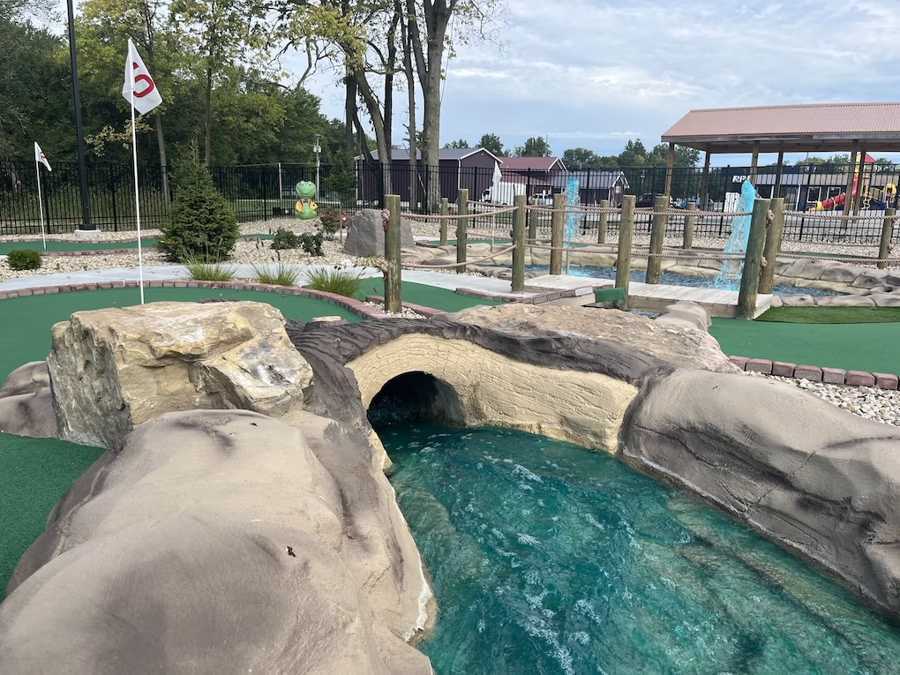 Putt Pirates mini-golf course with a water feature and rocky landscape.