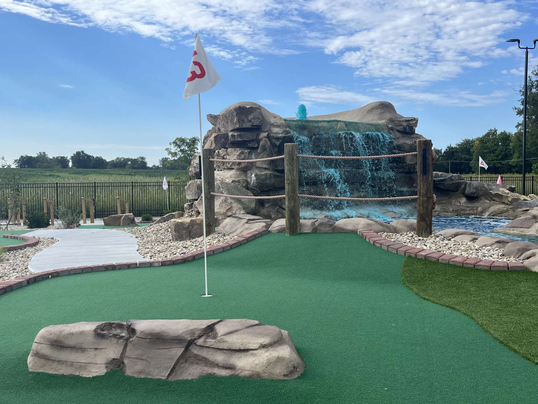 Putt Pirates mini golf course featuring a waterfall and green turf.